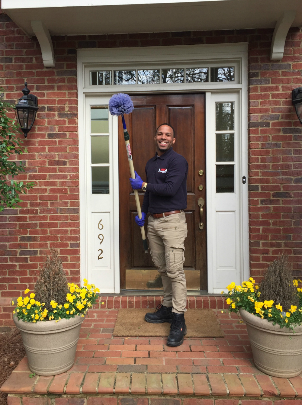 Arrow Exterminators team member posing in front of a home.